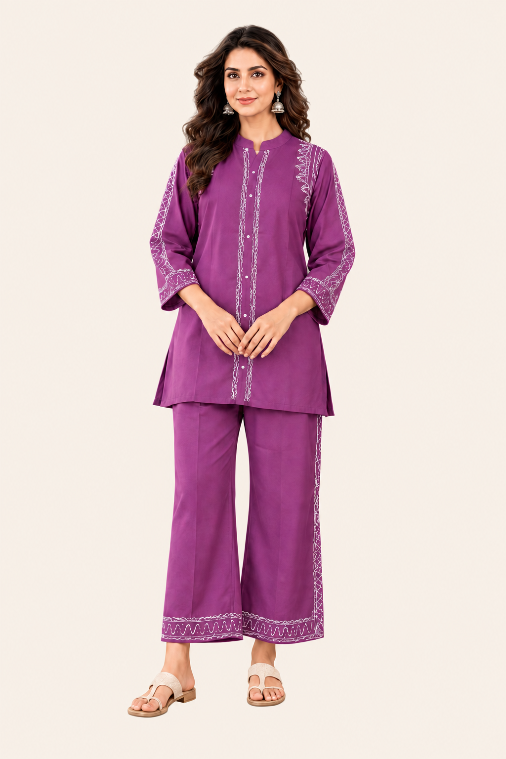 Full-length woman in the purple embroidered co-ord set on a light cream background